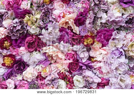 Flower texture background for wedding scene. Roses, peonies and hydrangeas, artificial flowers on the wall