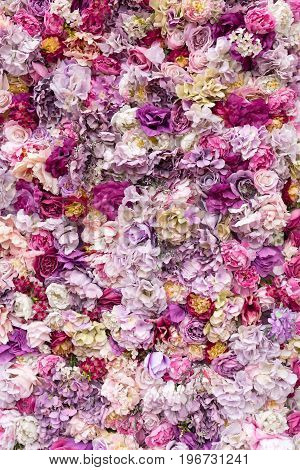 Flower texture background for wedding scene. Roses, peonies and hydrangeas, artificial flowers on the wall