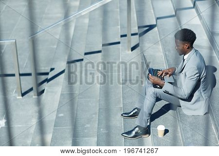Y generation specialist with laptop networking in urban environment