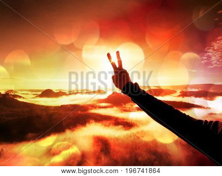 Film Effect.man Hand Make Victory To Sun. Misty Daybreak In A Beautiful Hills. Peaks Of Hills Are St