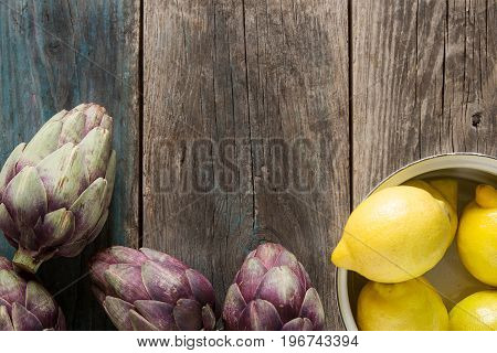 Baby Ripping Organic Artichokes With Lemon. Food For A Vegan And