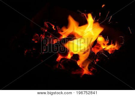 Hot sparking live-coals burning in a barbecue