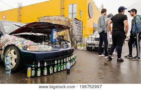 Orel Russia July 22 2017: Dynamica car festival. Car with open hood and many bottles horizontal