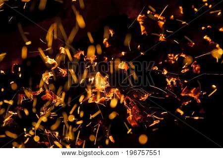 Hot sparking live-coals burning in a barbecue