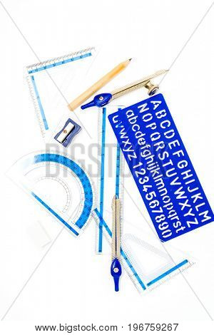 pen, ruler and setsquare on white background
