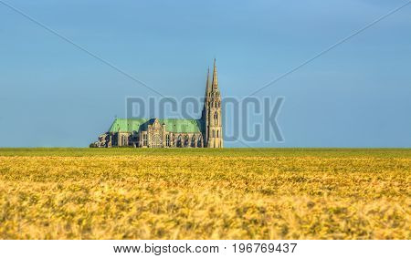 Image of the Cathedral of Our Lady of Chartres seen from outside of the city above the fields of cereals which surround the locality.This is a very famous Gothic cathedral which contains original stained glass from the 13th century.