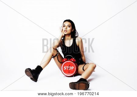 young pretty indian girl with red alarm clock posing cheerful on white background isolated, sexy modern woman concept, lifstyle people close up