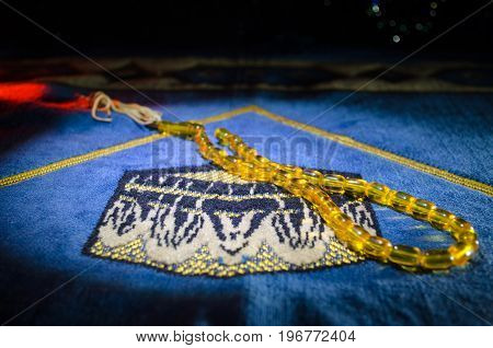 Holy Quran With Beads On A Prayer Mat, Muslim Tasbih Is A String Of Prayer Beads Which Is Traditiona