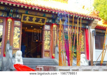 HONG KONG, CHINA - JANUARY 22, 2017: Close up of incenses burning up, inside of Wong Tai Sin Buddhist Temple to pray, in Hong Kong, China.
