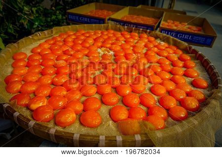 HONG KONG, CHINA - JANUARY 26, 2017: Orange yolks over a net without the egg white, in a market in fishermen town in lantau, Hong Kong, China.