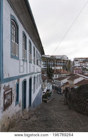 Ouro Preto is a colonial town in the Serra do Espinhaço mountains of eastern Brazil. It's known for its baroque architecture including bridges fountains and squares and its steep winding cobbled streets. Central Tiradentes Square is named after the martyr