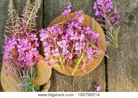 Flower Willowherb - Epilobium Angustifolium on wooden background . Top view .