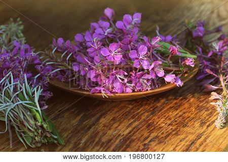 Flower Willowherb - Epilobium Angustifolium on wooden background .