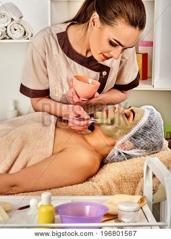 Collagen face mask. Facial skin treatment. Face of woman of elderly woman 50-60 years old receiving cosmetic procedure in beauty salon close up. Professional beautician number one.