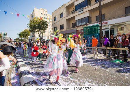 LIMASSOL, CYPRUS - FEBRUARY 26: Carnivalists in a silver cylinder hats joyfully follow the Limassol Municipality Band during the annual Carnival Parade, February 26, 2017 in Limassol.