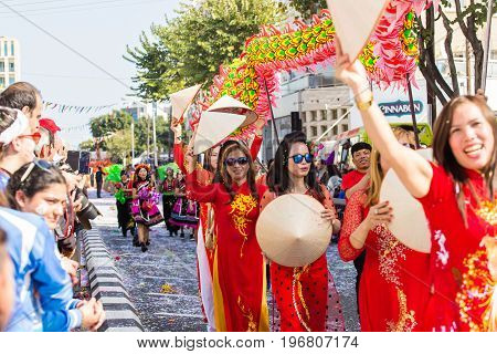 LIMASSOL, CYPRUS - FEBRUARY 26: Carnivalists in a silver cylinder hats joyfully follow the Limassol Municipality Band during the annual Carnival Parade, February 26, 2017 in Limassol.