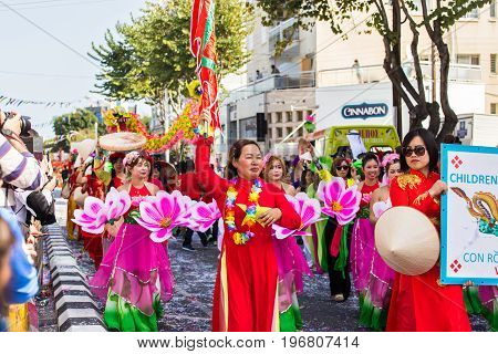 LIMASSOL, CYPRUS - FEBRUARY 26: Carnivalists in a silver cylinder hats joyfully follow the Limassol Municipality Band during the annual Carnival Parade, February 26, 2017 in Limassol.