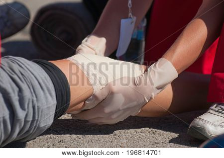 Paramedic Treating A Knee Injury, Outdoors, Color Image, Close Up