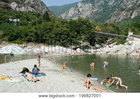People Swimming And Sunbathing On Maggia River At Ponte Brolla