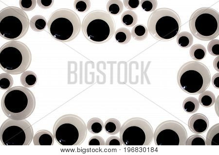 Googly eye border. A frame of funny toy eyes. Jiggly eye plastic craft item used in fun toy making.