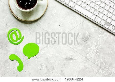 customer support company office with contact us sign and coffee on tone desk background top view mockup