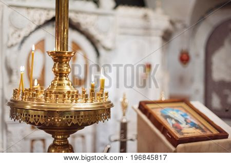 Orthodox christian church interior. Icon and candles during worship