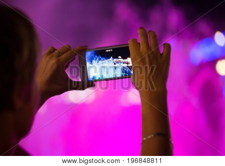 People holding their smart phone shooting video or photo.
