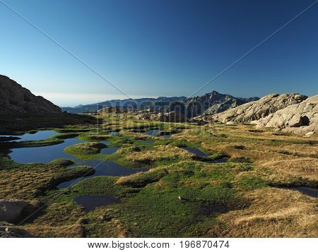 Beautiful Mountain Scenery With Blue Lagoons In The Meadow