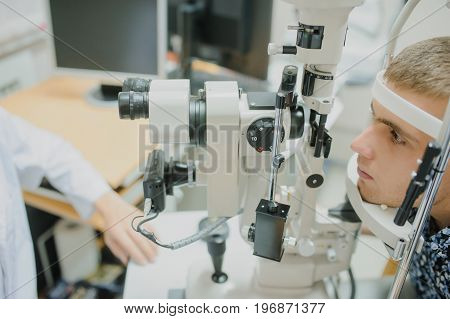Young Beautiful Two Doctors /eye Specialist/optometrist In An Ophthalmologic Clinic Examines A Woman