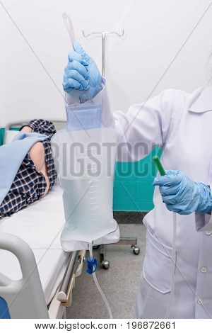 Doctor gives her patient for enema to resolve constipation problem.