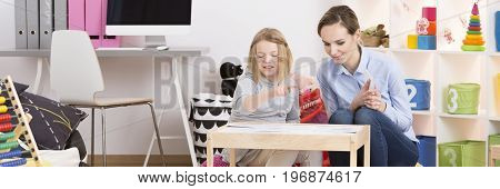 School girl during her test on extra classes with psychotherapist