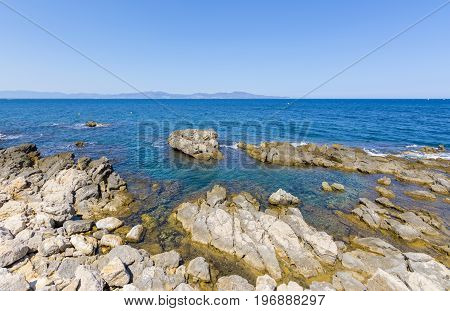 Rocky Mediterranean coast of l'Escala village in Costa Brava, Spain.