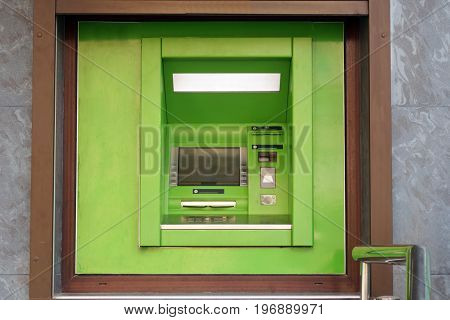 Outdoor ATM cash machine. Withdraw money from ATM machine. Bankomat on a wall.