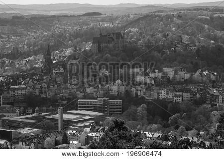MARBURG GERMANY - APRIL 18 2015: The new and the old part of the city from the surrounding hills. Black and white. Marburg is a university town in the German federal state (Bundesland) of Hessen.