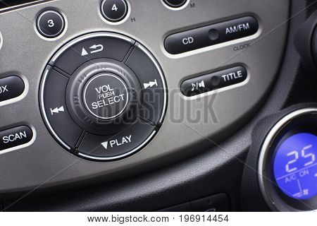 Controller button of media audio in car interior for radio and audio volume adjustment. selective focus. Automotive part concept.