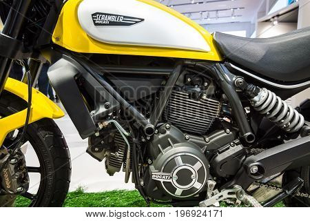 BERLIN - MAY 02 2015: Showroom. Detail of the engine and the fuel tank motorcycle Ducati Scrambler Classic. Produced since 2015.