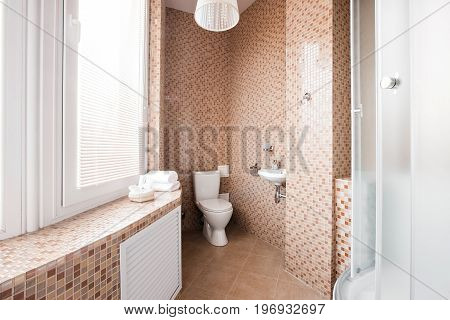 Modern luxury bathroom with shower cabin and window. Interior design