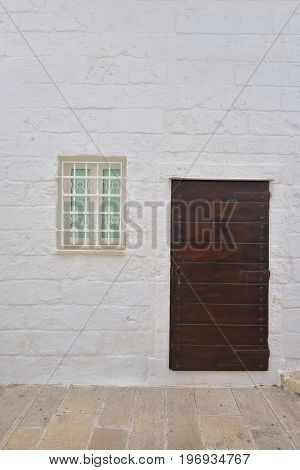 Traditional facade of south adriatic sea house with door and window minimalist decorated in small village of Monopoli south Italy