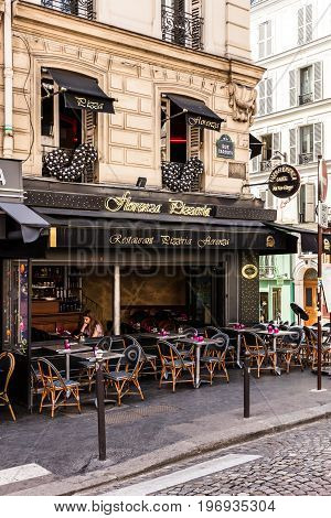 Paris France - June 22 2017: A traditional italian restaurant Florenza Pizzeria on the Montmartre Hill in Paris. Parisians and tourists enjoy food and drinks in the summer day.