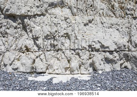A close-up of the layers of Chalk in the white cliffs along the coastline in East Sussex UK.