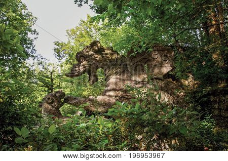 Bomarzo, Italy - May 20, 2013. View of sculpture amidst the vegetation in the Park of Bomarzo. Also known as Park of Monsters, it was created to surprise the visitor with surrealistic works in stone. Lazio region, central Italy