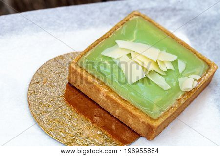 Green Keylime Tart Pastry With A Cookie Crust And White Chocolate Flakes
