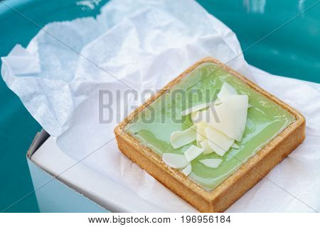 Green Keylime Tart Pastry With A Cookie Crust And White Chocolate Flakes