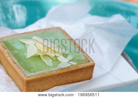Green Keylime Tart Pastry With A Cookie Crust And White Chocolate Flakes