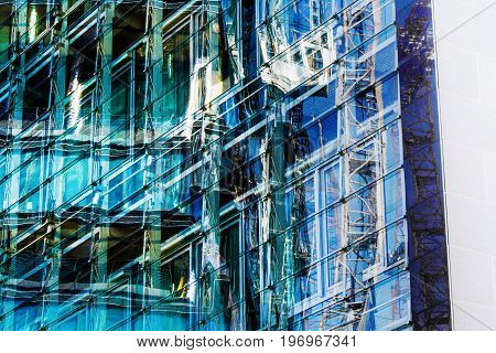 The Reflection in a glass facade of a modern copany headquarters