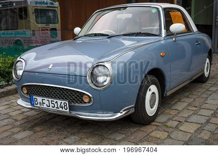 BERLIN - MAY 10 2015: City car Nissan Figaro 1991. The 28th Berlin-Brandenburg Oldtimer Day