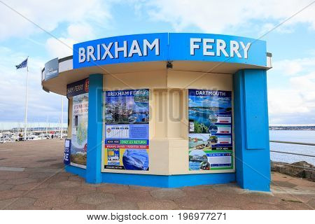 A brightly coloured Kiosk on Torquay Promenade which is selling fishing trips and ferries to tourists.  Torquay, Devon, 2017
