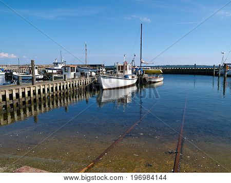Typical traditional colorful small Danish fishing boats in a harbour at Funen Denmark