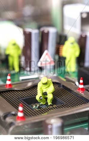 Toy technicians are repairing or diagnosing a motherboard. Under Construction concept. Selective focus.