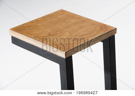 Studio Shot Of Stylish Barstool With Wooden Top And Black Metallic Legs Standing On White